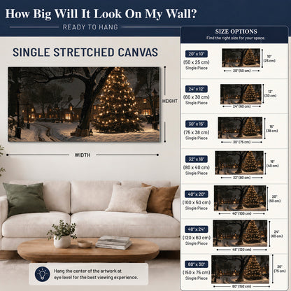 A tall illuminated Christmas tree beneath dark branches beside warmly lit snowy cottages single canvas wall art size guide above a sofa; room view is illustrative