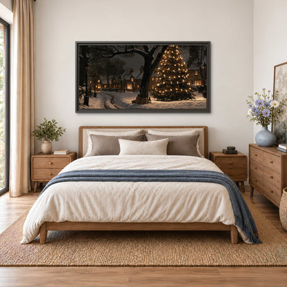 A tall illuminated Christmas tree beneath dark branches beside warmly lit snowy cottages single framed canvas wall art styled in an interior