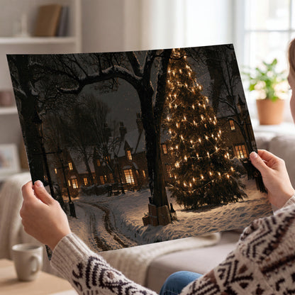 A tall illuminated Christmas tree beneath dark branches beside warmly lit snowy cottages single poster print held in hands