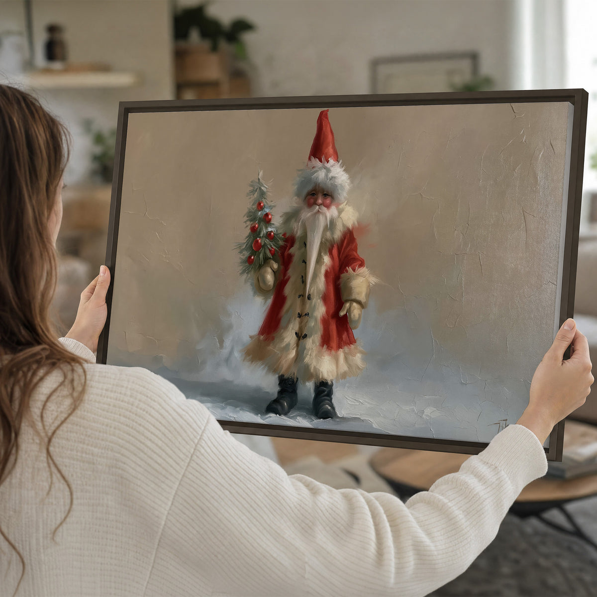 A small storybook Santa in a red coat holding a miniature Christmas tree against a soft neutral background single framed canvas wall art held in hands