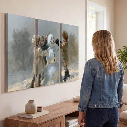 Two children putting the finishing touches on a snowman in a soft snowy landscape 3 piece canvas wall art three panel arrangement on a wall