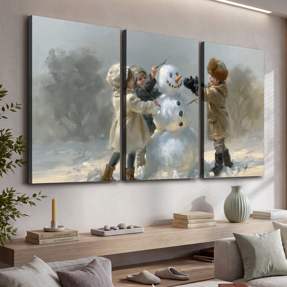 Two children putting the finishing touches on a snowman in a soft snowy landscape 3 piece canvas wall art displayed in a console