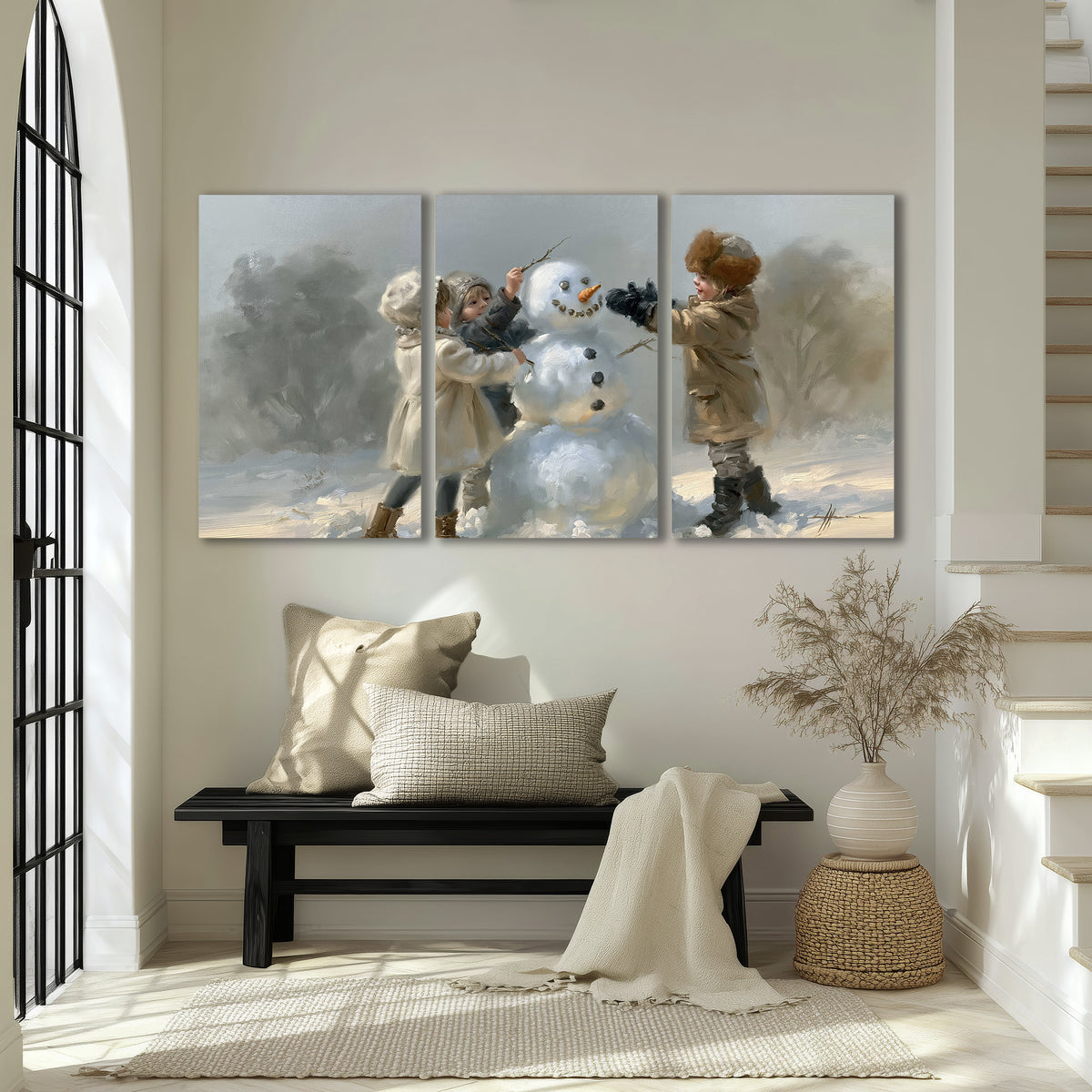 Two children putting the finishing touches on a snowman in a soft snowy landscape 3 piece canvas wall art displayed in a entryway