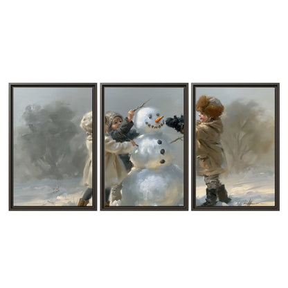 Two children putting the finishing touches on a snowman in a soft snowy landscape 3 piece framed canvas wall art viewed straight on