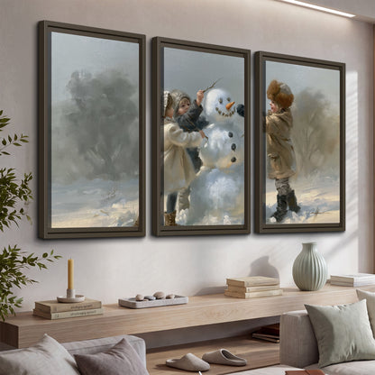 Two children putting the finishing touches on a snowman in a soft snowy landscape 3 piece framed canvas wall art displayed in a console