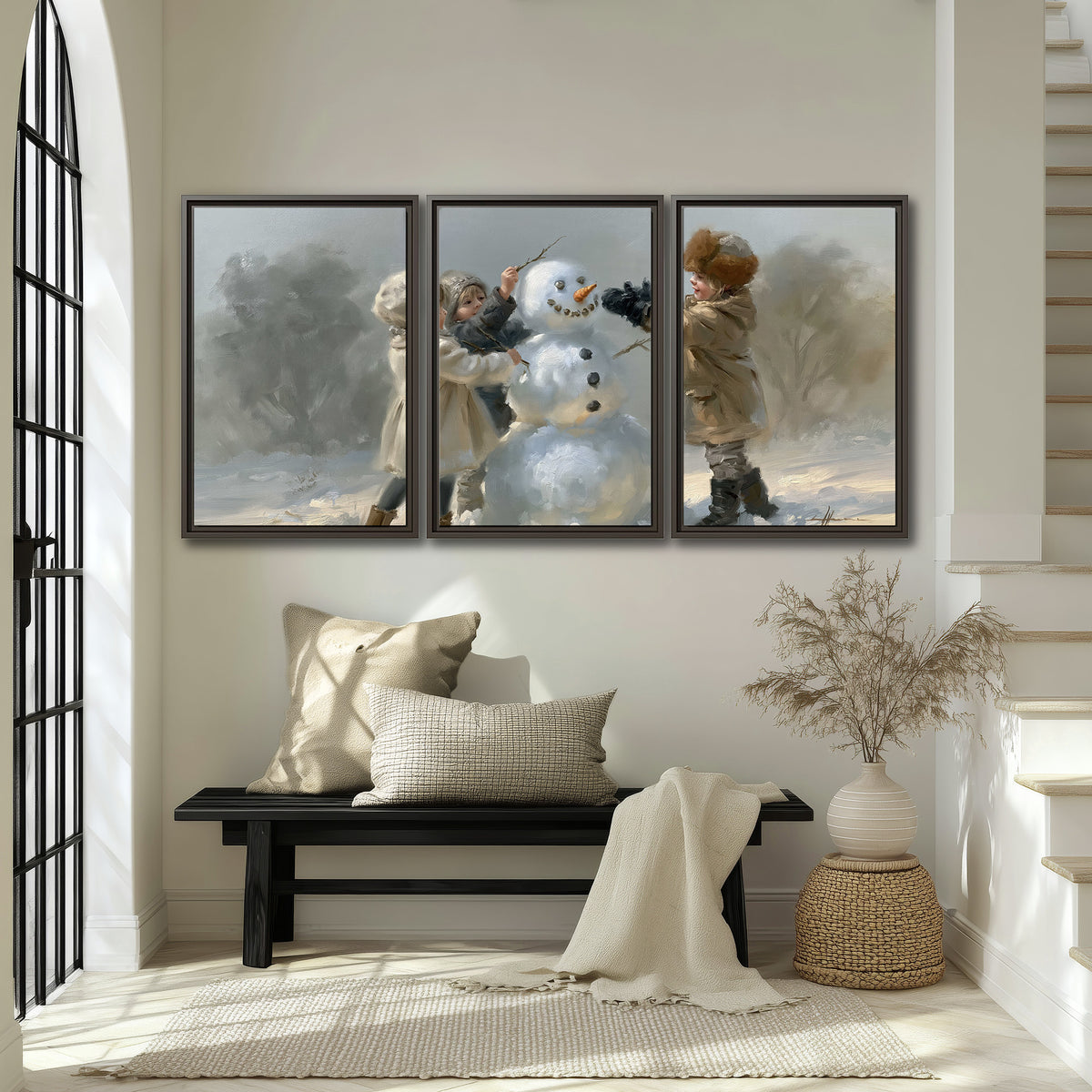 Two children putting the finishing touches on a snowman in a soft snowy landscape 3 piece framed canvas wall art displayed in a entryway