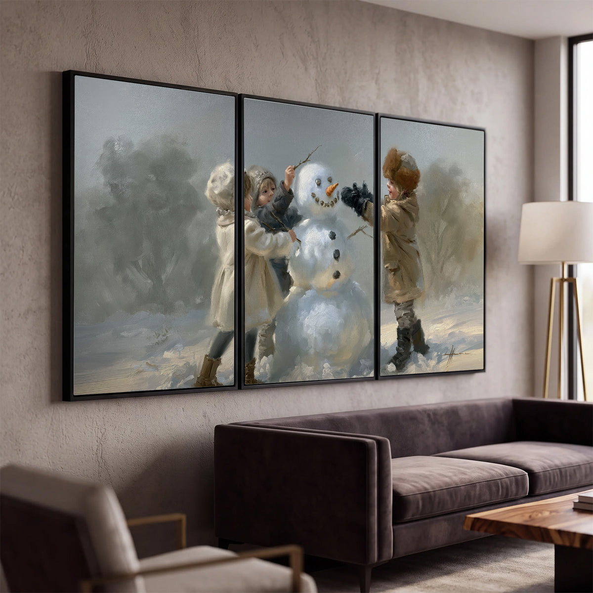 Two children putting the finishing touches on a snowman in a soft snowy landscape 3 piece framed canvas wall art displayed in a modern living room