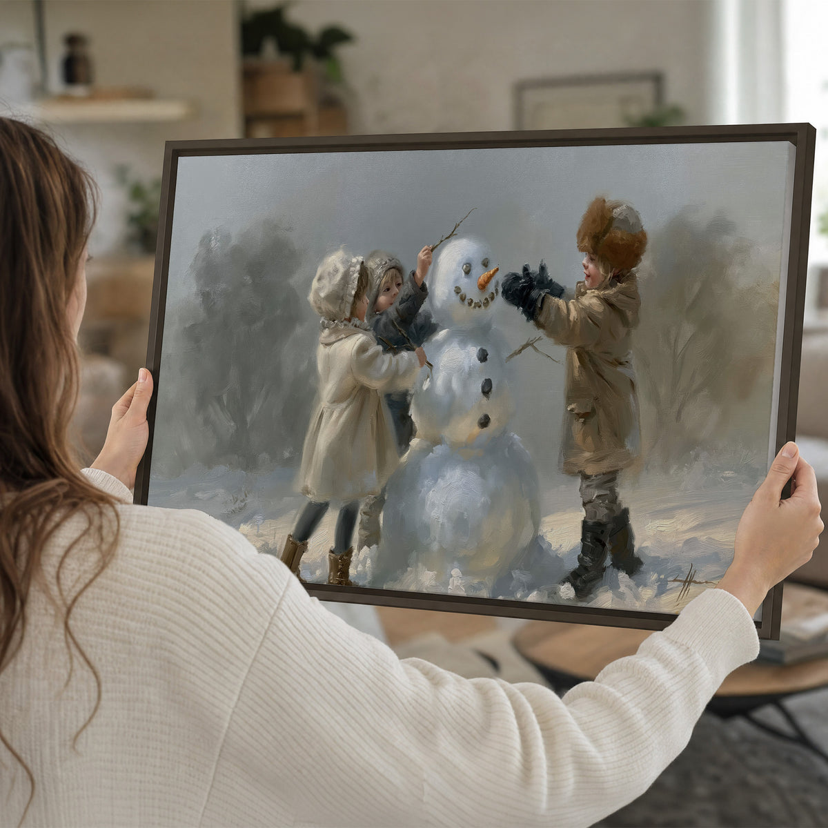 Two children putting the finishing touches on a snowman in a soft snowy landscape single framed canvas wall art held in hands