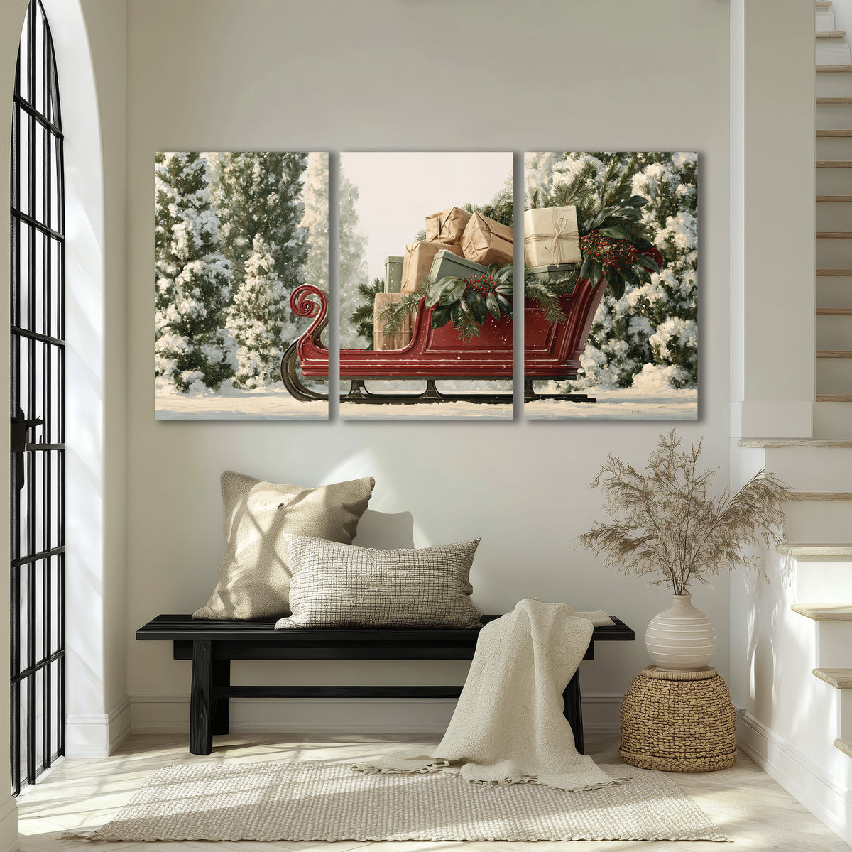 A red sleigh filled with wrapped gifts and evergreen branches among snowy fir trees 3 piece canvas wall art displayed in a entryway