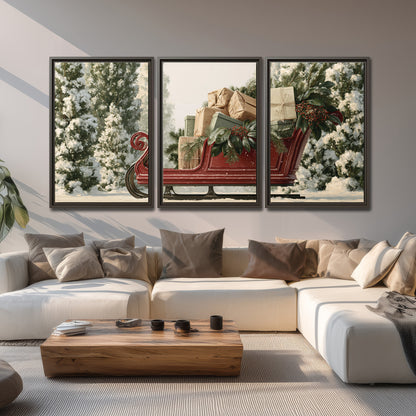 A red sleigh filled with wrapped gifts and evergreen branches among snowy fir trees 3 piece framed canvas wall art displayed in a living room
