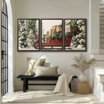 A red sleigh filled with wrapped gifts and evergreen branches among snowy fir trees 3 piece framed canvas wall art displayed in a entryway
