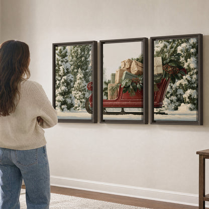 A red sleigh filled with wrapped gifts and evergreen branches among snowy fir trees 3 piece framed canvas wall art three panel arrangement on a wall