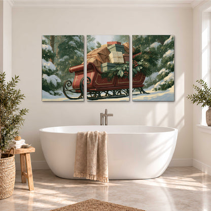A red sleigh stacked with warm neutral gifts beneath snow-covered evergreen branches 3 piece canvas wall art styled in an interior