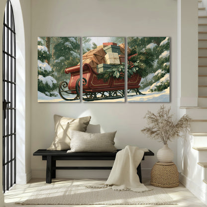 A red sleigh stacked with warm neutral gifts beneath snow-covered evergreen branches 3 piece canvas wall art displayed in a entryway