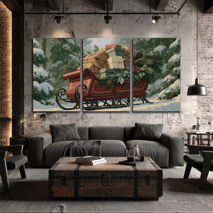 A red sleigh stacked with warm neutral gifts beneath snow-covered evergreen branches 3 piece canvas wall art displayed in a industrial room