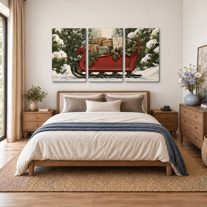 A decorative red holiday sleigh carrying wrapped presents and greenery through a snowy woodland 3 piece canvas wall art styled in an interior