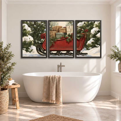 A decorative red holiday sleigh carrying wrapped presents and greenery through a snowy woodland 3 piece framed canvas wall art styled in an interior
