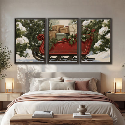 A decorative red holiday sleigh carrying wrapped presents and greenery through a snowy woodland 3 piece framed canvas wall art displayed in a bedroom