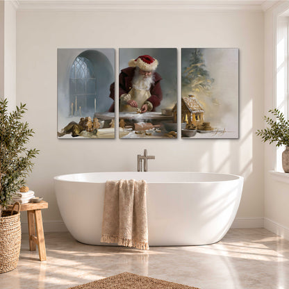 Santa working with dough beside a gingerbread house in a softly lit Christmas kitchen 3 piece canvas wall art styled in an interior
