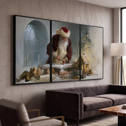 Santa working with dough beside a gingerbread house in a softly lit Christmas kitchen 3 piece framed canvas wall art displayed in a modern living room
