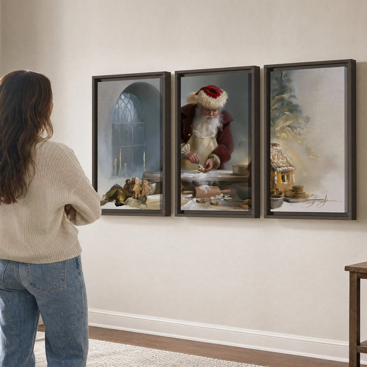 Santa working with dough beside a gingerbread house in a softly lit Christmas kitchen 3 piece framed canvas wall art three panel arrangement on a wall