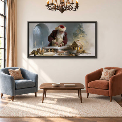 Santa working with dough beside a gingerbread house in a softly lit Christmas kitchen single framed canvas wall art styled in an interior