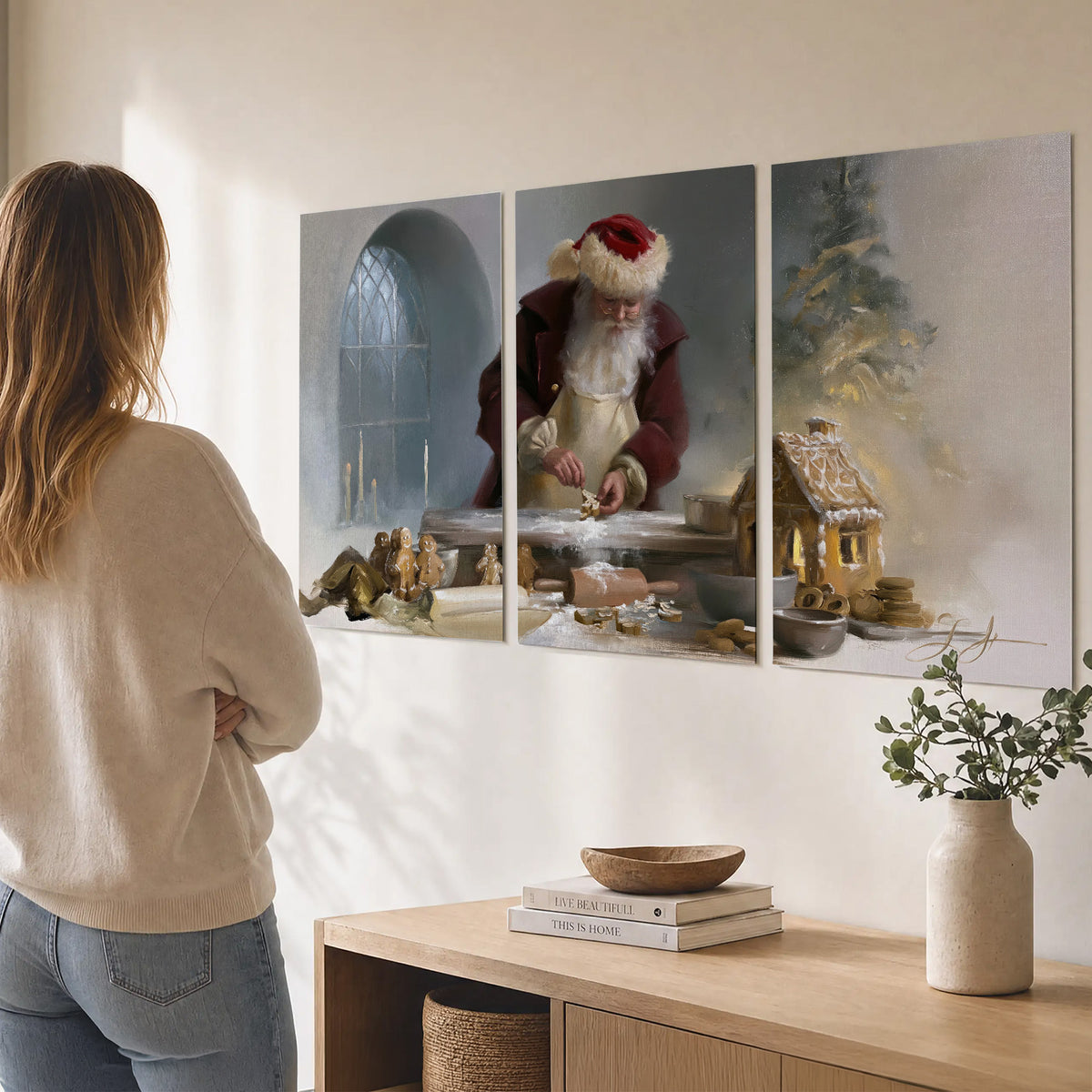 Santa working with dough beside a gingerbread house in a softly lit Christmas kitchen set of 3 poster prints three panel arrangement on a wall