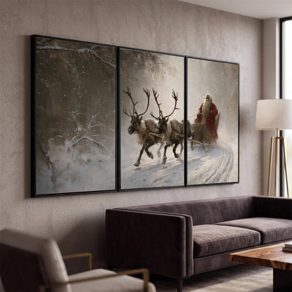 Santa riding a reindeer-drawn sleigh along a winding snowy woodland path 3 piece framed canvas wall art displayed in a modern living room