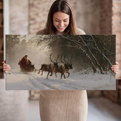 A reindeer team pulling Santa through a quiet snow-covered forest single canvas wall art held in hands