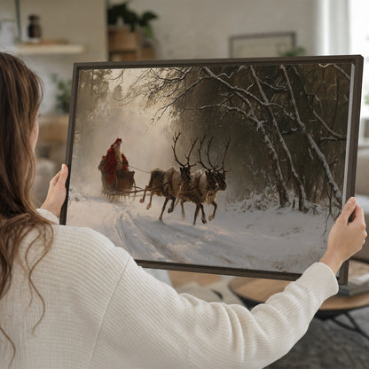 A reindeer team pulling Santa through a quiet snow-covered forest single framed canvas wall art held in hands