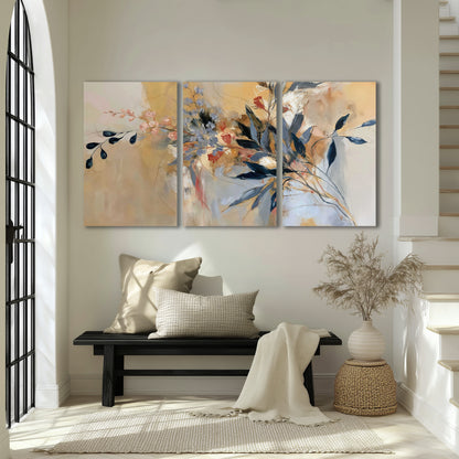 Loose dark blue leaves and pale blossoms on a warm beige painterly background 3 piece canvas wall art displayed in a entryway