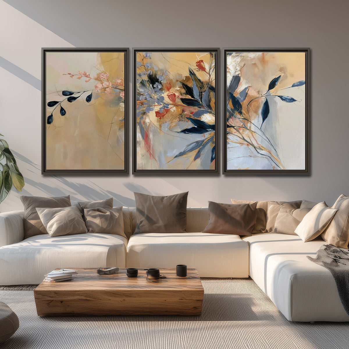 Loose dark blue leaves and pale blossoms on a warm beige painterly background 3 piece framed canvas wall art displayed in a living room