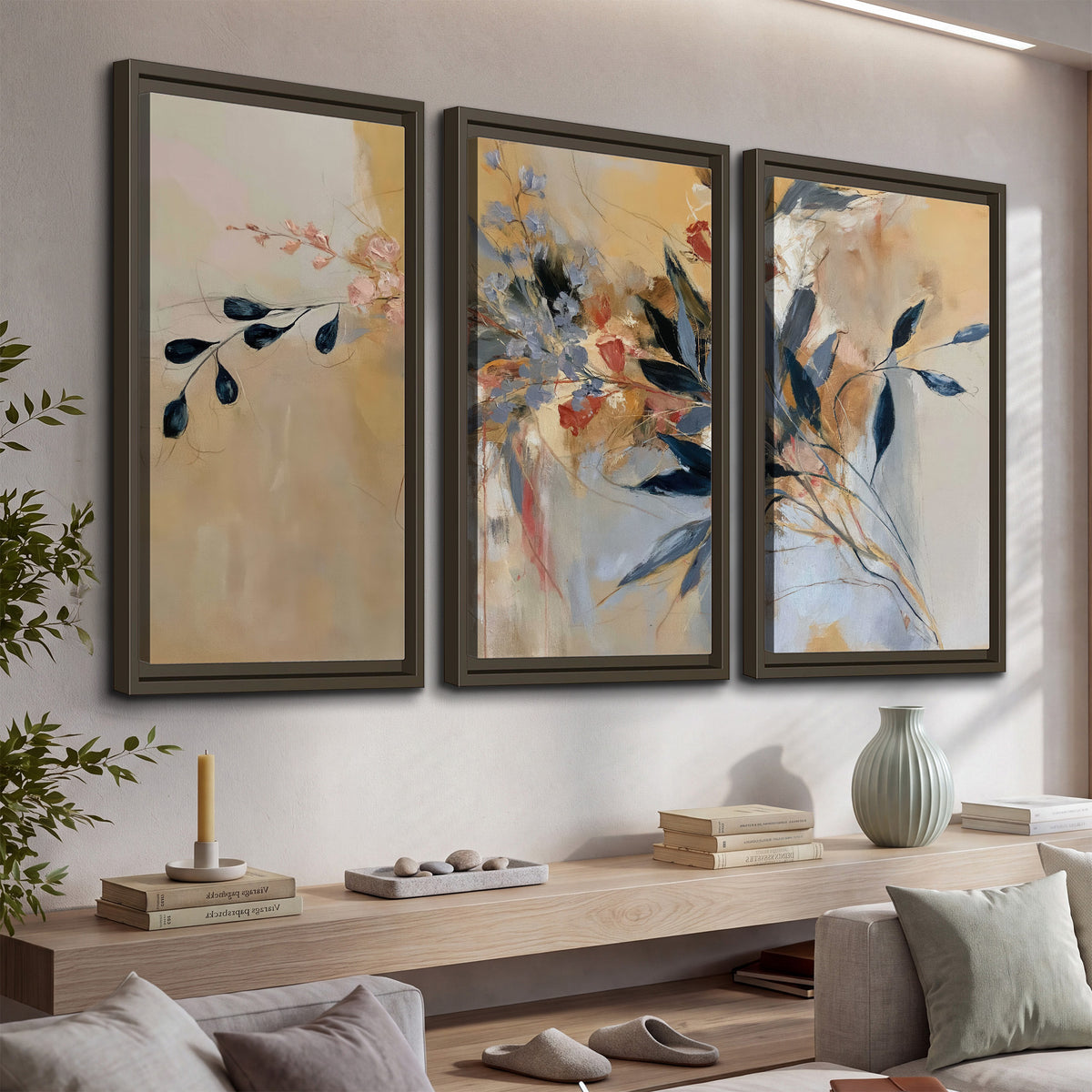 Loose dark blue leaves and pale blossoms on a warm beige painterly background 3 piece framed canvas wall art displayed in a console