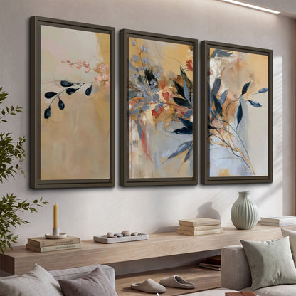 Loose dark blue leaves and pale blossoms on a warm beige painterly background 3 piece framed canvas wall art displayed in a console