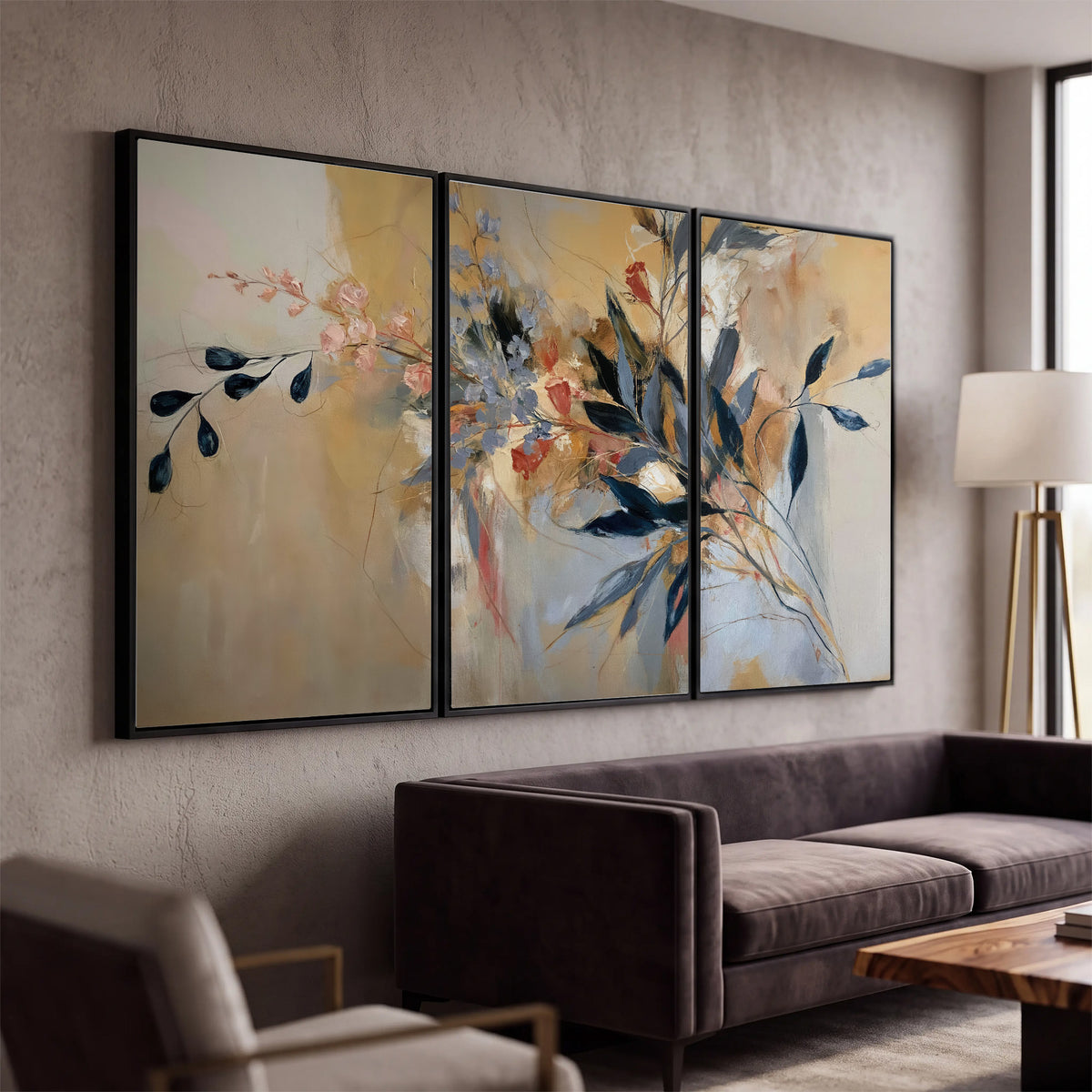 Loose dark blue leaves and pale blossoms on a warm beige painterly background 3 piece framed canvas wall art displayed in a modern living room