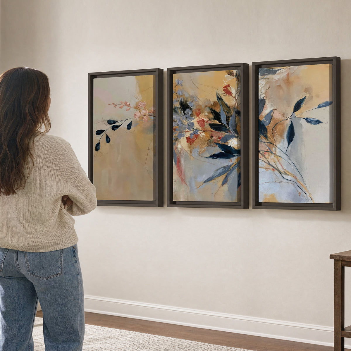 Loose dark blue leaves and pale blossoms on a warm beige painterly background 3 piece framed canvas wall art three panel arrangement on a wall