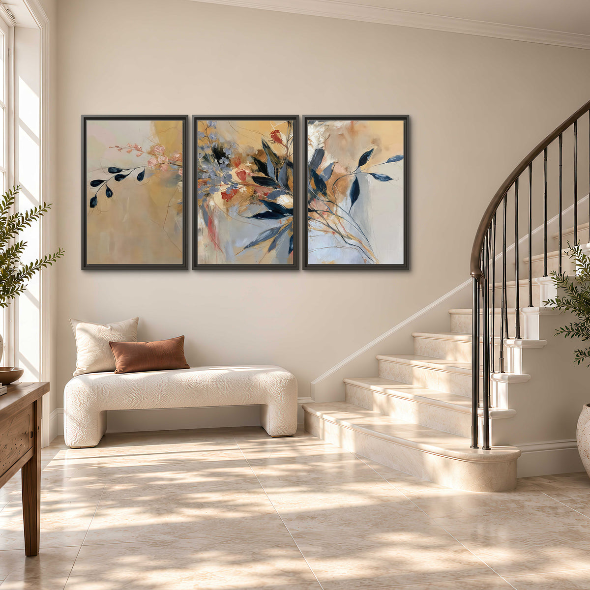 Loose dark blue leaves and pale blossoms on a warm beige painterly background 3 piece framed canvas wall art styled in an interior