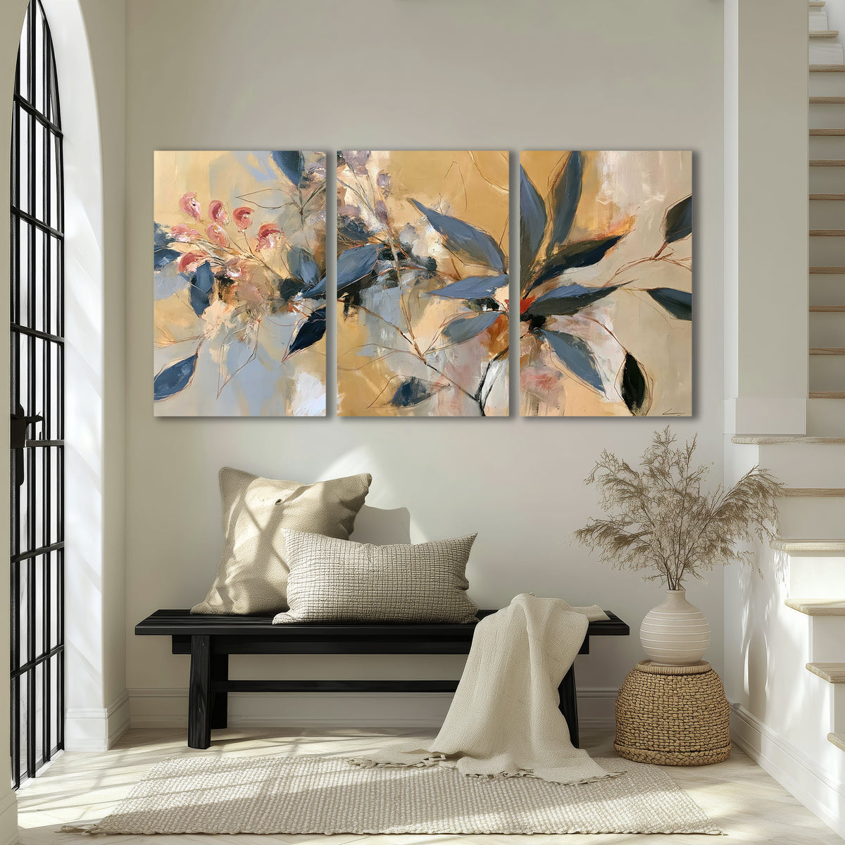 Layered navy leaves and muted pink blossoms against a golden cream background 3 piece canvas wall art displayed in a entryway