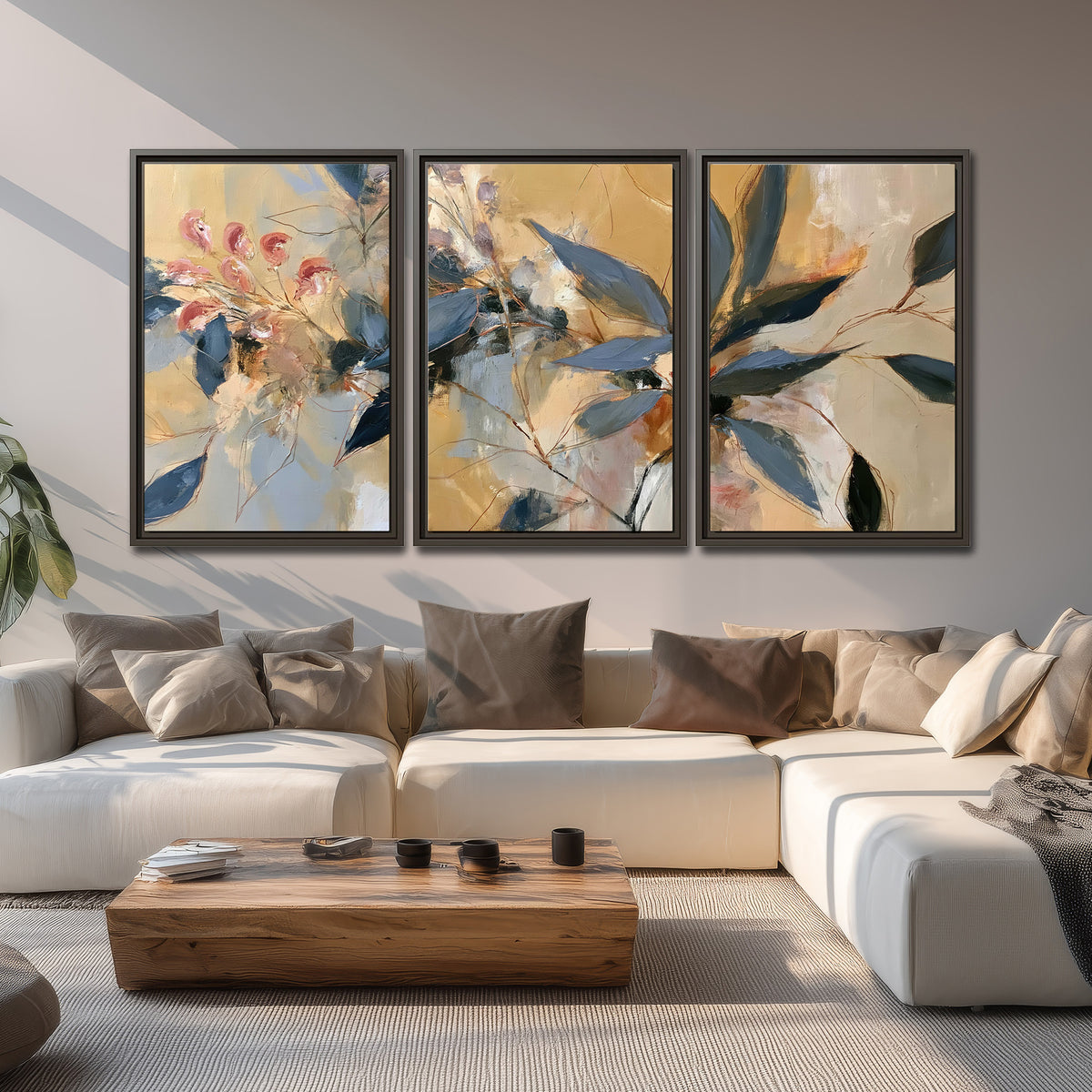 Layered navy leaves and muted pink blossoms against a golden cream background 3 piece framed canvas wall art displayed in a living room