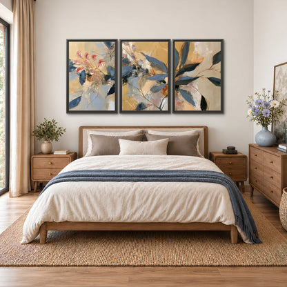Layered navy leaves and muted pink blossoms against a golden cream background 3 piece framed canvas wall art styled in an interior