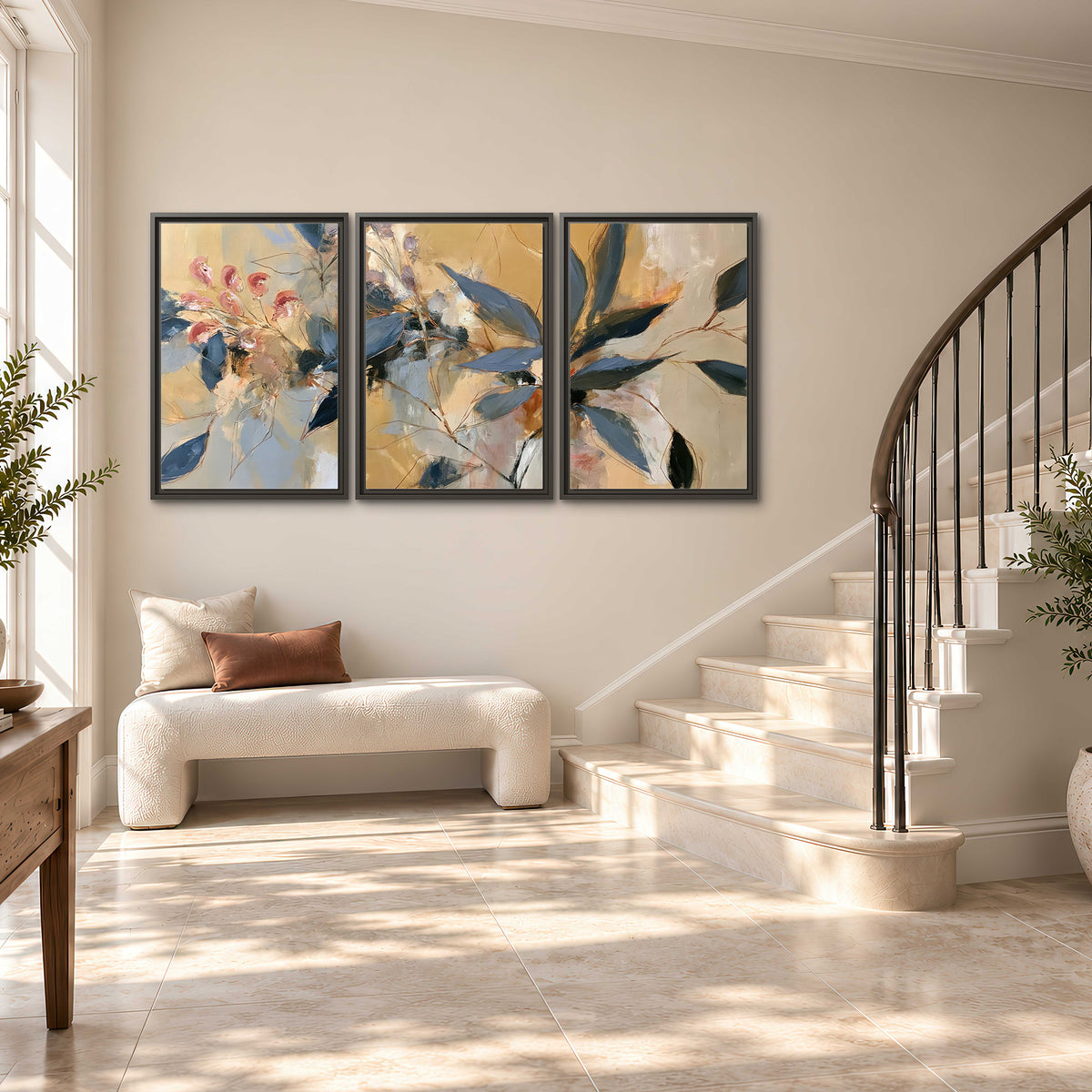 Layered navy leaves and muted pink blossoms against a golden cream background 3 piece framed canvas wall art styled in an interior