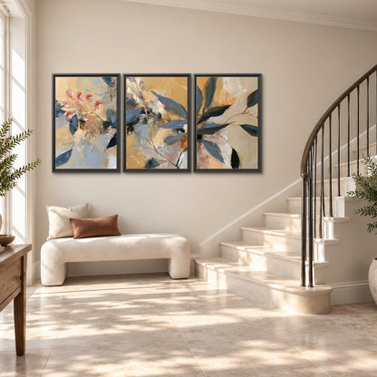 Layered navy leaves and muted pink blossoms against a golden cream background 3 piece framed canvas wall art styled in an interior