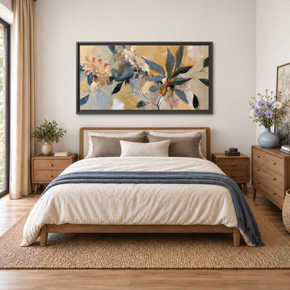 Layered navy leaves and muted pink blossoms against a golden cream background single framed canvas wall art styled in an interior