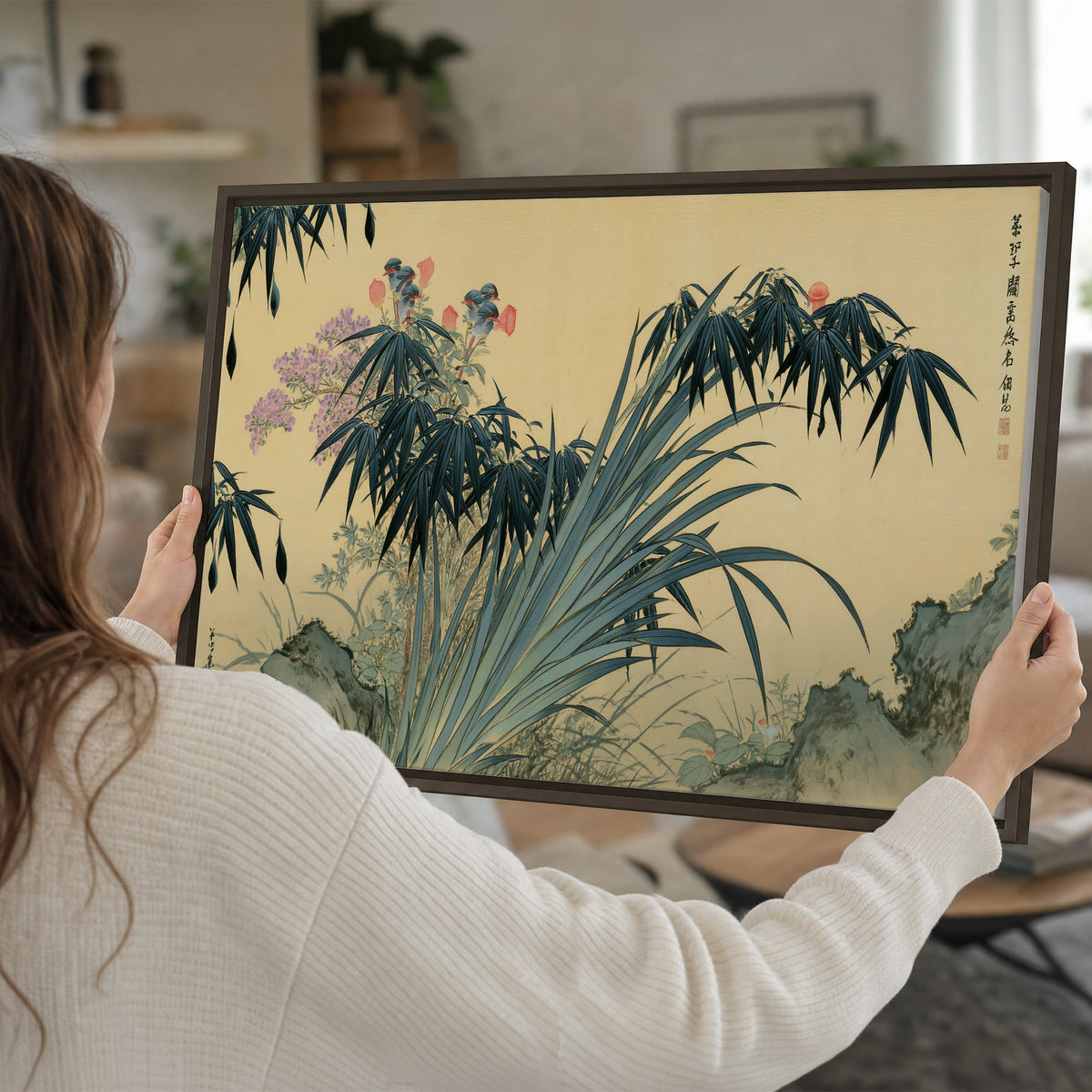 Graceful bamboo leaves and small blossoms on a warm parchment-toned background single framed canvas wall art held in hands