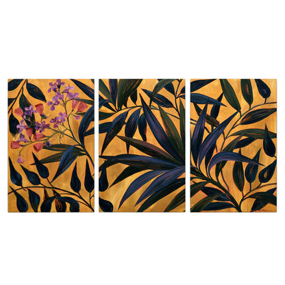 Dark pointed bamboo leaves across an ochre background with small pink floral accents 3 piece canvas wall art viewed straight on