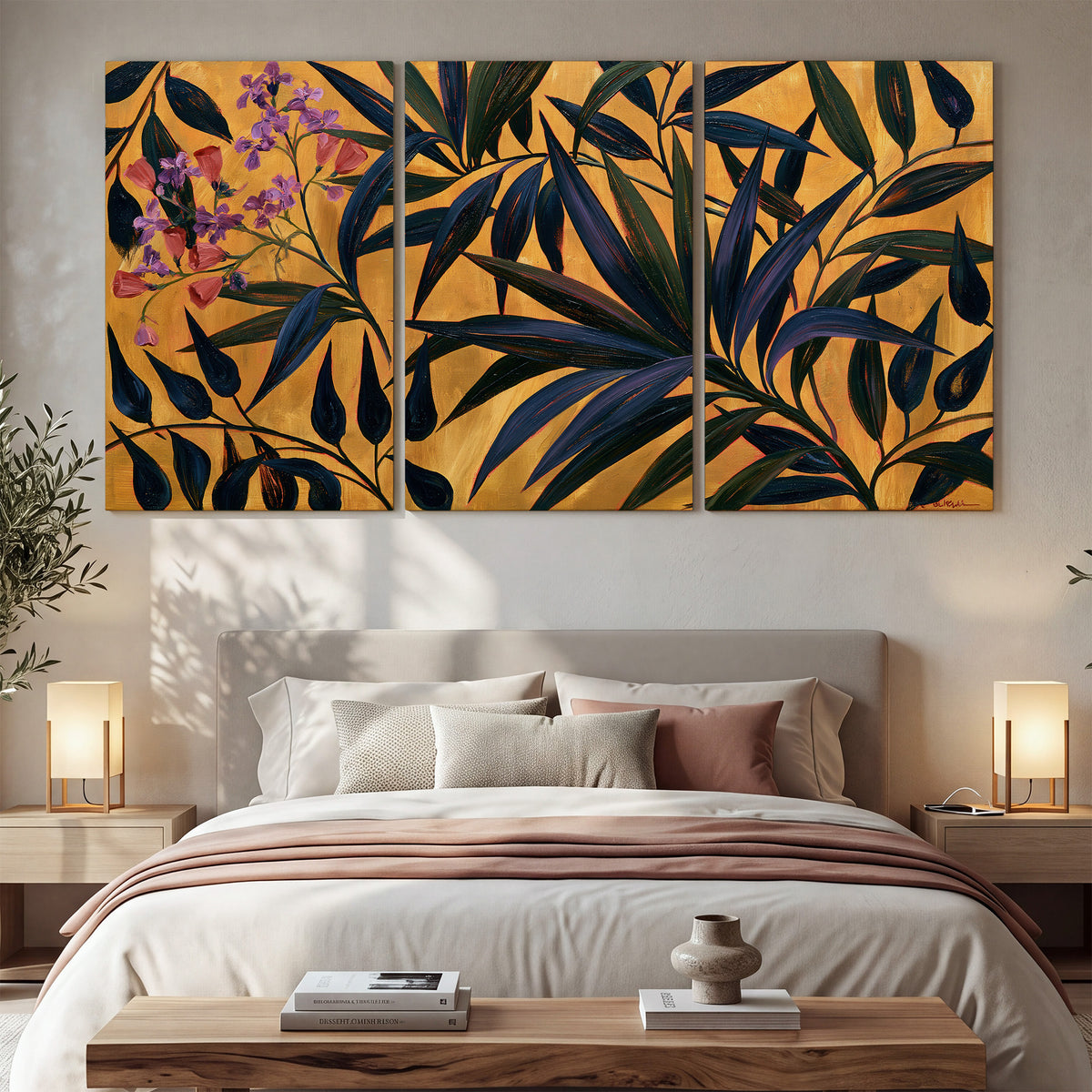 Dark pointed bamboo leaves across an ochre background with small pink floral accents 3 piece canvas wall art displayed in a bedroom