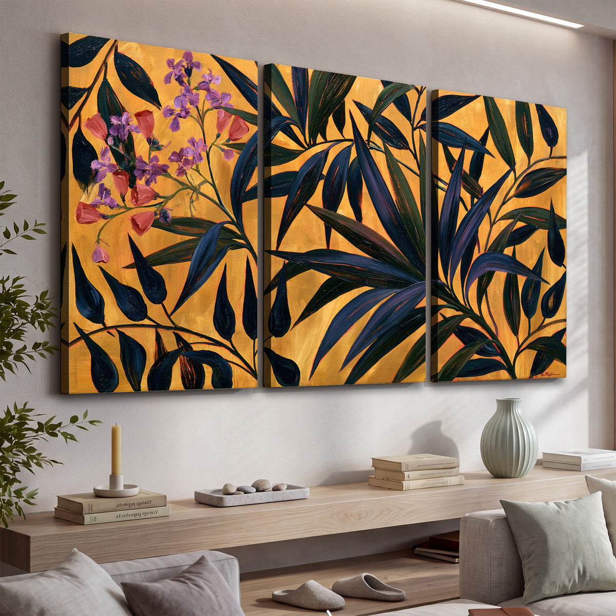 Dark pointed bamboo leaves across an ochre background with small pink floral accents 3 piece canvas wall art displayed in a console