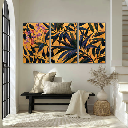 Dark pointed bamboo leaves across an ochre background with small pink floral accents 3 piece canvas wall art displayed in a entryway