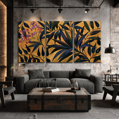 Dark pointed bamboo leaves across an ochre background with small pink floral accents 3 piece canvas wall art displayed in a industrial room