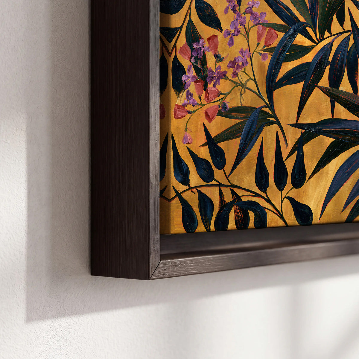Dark pointed bamboo leaves across an ochre background with small pink floral accents 3 piece framed canvas wall art material and edge close up